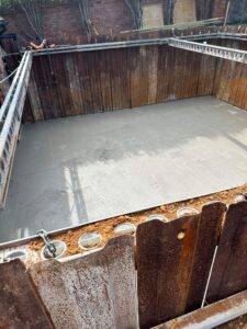 Concrete base slab cast within the sheet-pile excavation – basement construction in Beaconsfield, Buckinghamshire