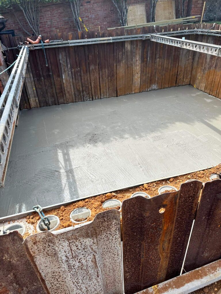 Concrete base slab cast within the sheet-pile excavation – basement construction in Beaconsfield, Buckinghamshire